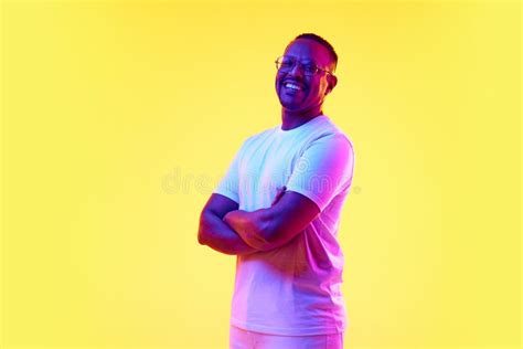 Portrait Of Smiling Young African American Man In Glasses White T