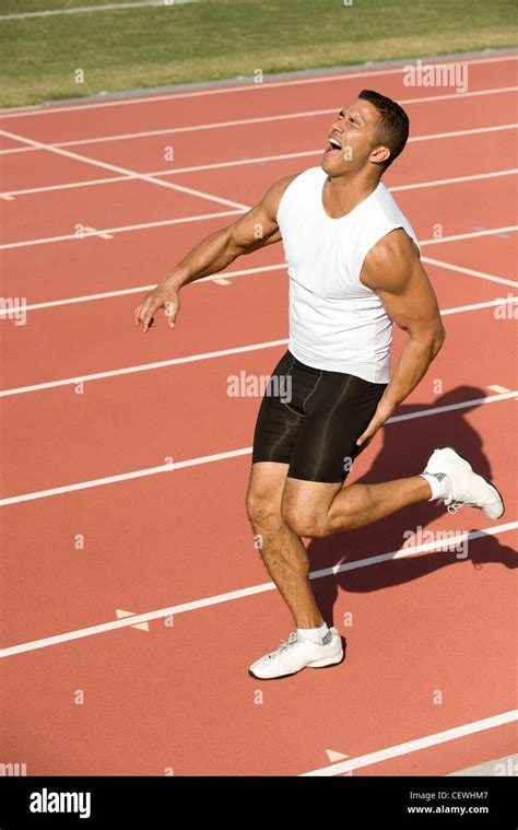 Runner injured while running on track Stock Photo - Alamy