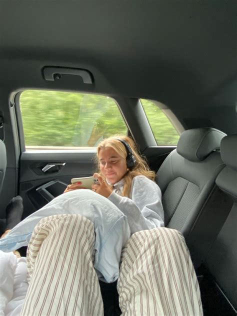 A Woman Laying In The Back Seat Of A Car