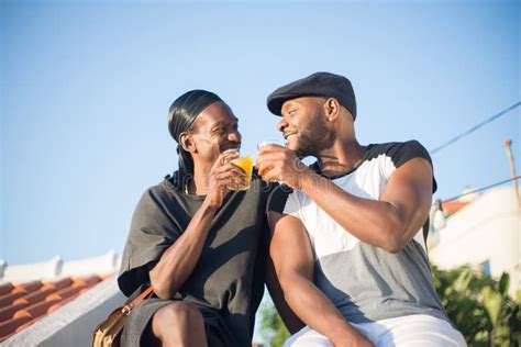 Portrait Of African Gay Couple With Glasses Of Juice Stock Photo Image Of Summer Casual