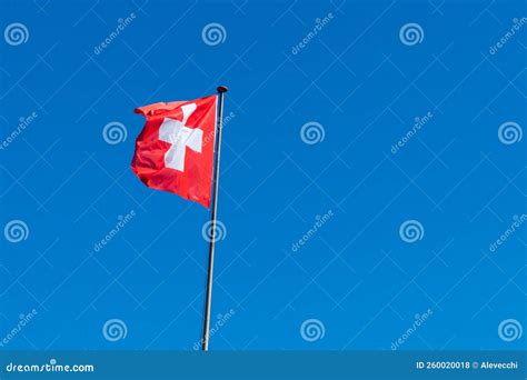 Switzerland Flag With Blue Sky In The Background Stock Photo Image Of