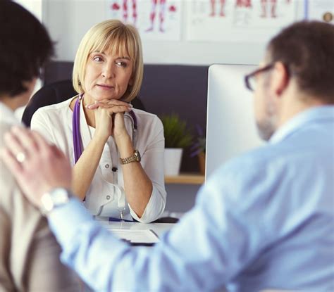 Premium Photo Doctor Talking To Her Male Patient At Office