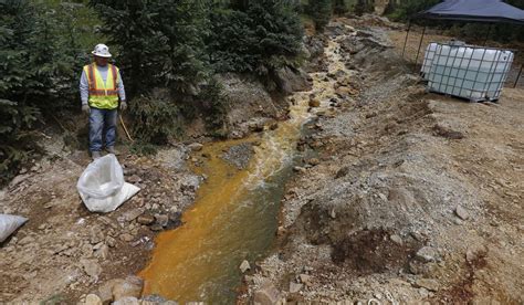 An Environmental Protection Agency Contractor Works On The Cleanup In The Aftermath Of The