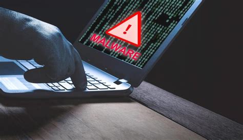 Premium Photo Hacker Hand Using Laptop To Send Malware Program Into