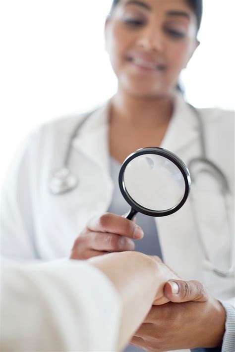 Female Doctor With Magnifying Glass Photograph By Science Photo Library Pixels