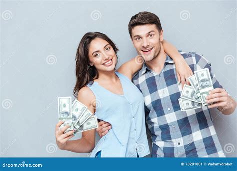 Couple Showing Their Money Over Gray Background Stock Image Image Of