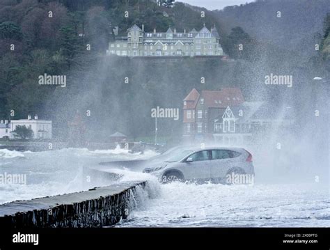 Large Storm Waves Crash Into Harbour Defences And Parked Cars At