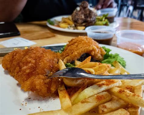 Crispy Chicken Chop With Fries And Salad Dinner On The Table Stock