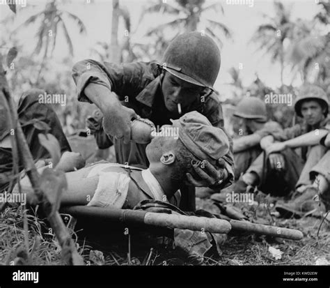 Us Navy Corpsman Gives A Drink To Wounded Marine On Guam July 1944 During World War 2 Bsloc