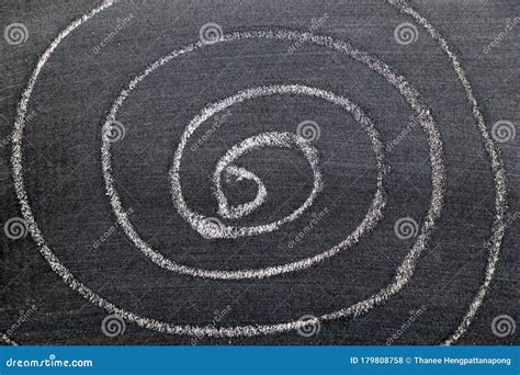 White Chalk Hand Drawing In Spiral Shape On Black Board Background