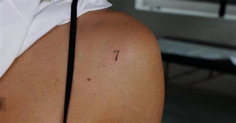 Little tattoo of the number "7" located on the