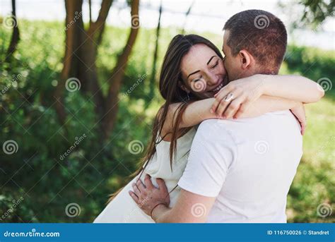 Happy And Young Pregnant Couple Hugging In Nature Romantic Moments