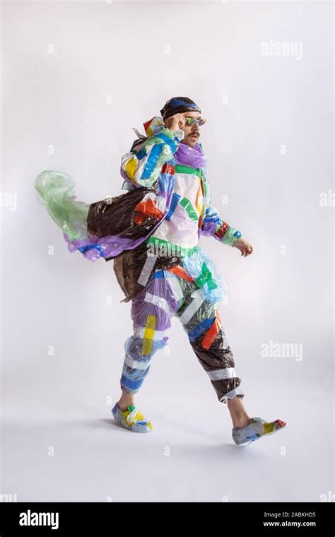 Man wearing plastic on white background. Male model in clothes made of garbage. Fashion, style ...