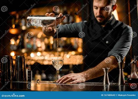 Professional Bartender Pouring An Alcohol From The Measuring Cup