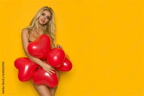 Beautiful Woman In Lingerie Is Posing With Red Heart Shaped Balloons Stock Photo Adobe Stock