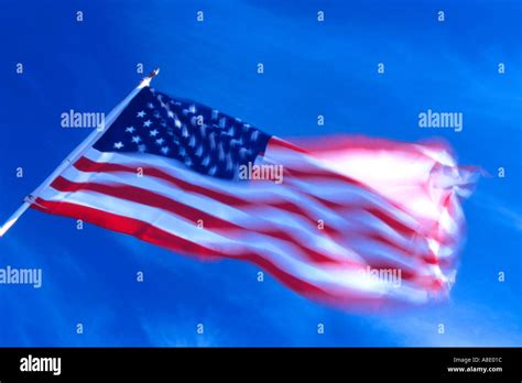 American flag flying in wind Stock Photo - Alamy