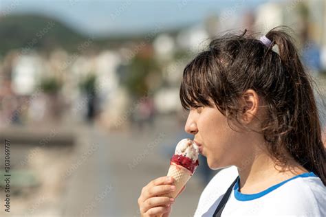 The girl eating a delicious ice cream Stock Photo | Adobe Stock