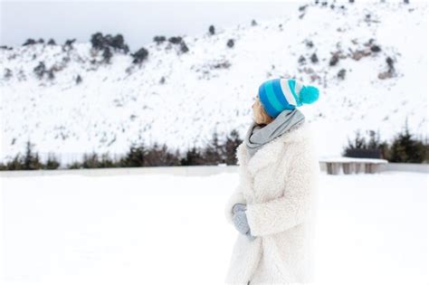 Premium Photo Portrait Of Happy Beautiful Blonde Woman With Snow In Winter Nature