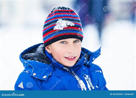 Funny Cheerful Boy In Jacket And Hat Playing Outdoors In Winter Stock