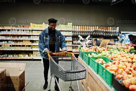 Stylish casual african american man at jeans jacket and black beret at