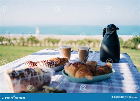 A Picnic At The Seaside Beach Breakfast With Coffee Croissants And