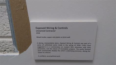 This man stuck a museum label next to a hole in his office wall and turned it into modern art ...