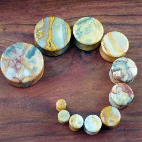 A Bracelet Made Out Of Marbles Sitting On Top Of A Wooden Table