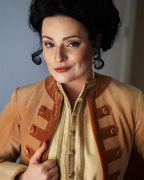 A Woman In A Brown Jacket Posing For The Camera