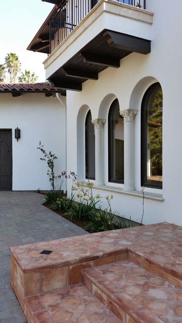 Corbels Supporting Balcony And Round Top Inset Windows At Entry