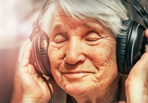 Old Woman In Headphones Listening To Music Senior Living Options Llc