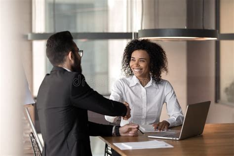 Smiling Diverse Business Partners Handshake Closing Deal At Meeting