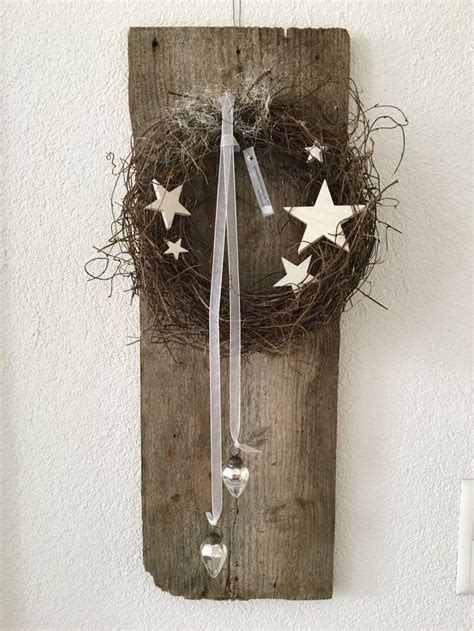 A Bird S Nest With Three White Stars Hanging From The Side On A Wall