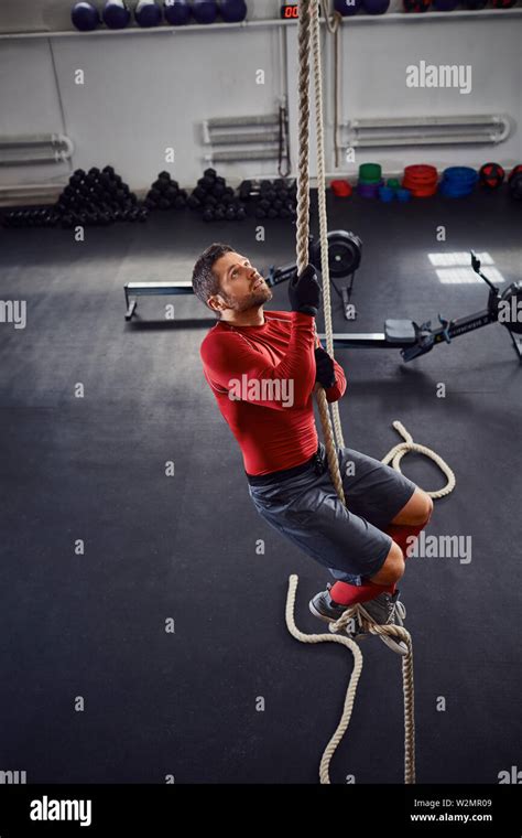 Athlete During Rope Climb Exercise At Gym Stock Photo Alamy