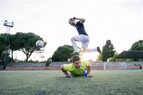 Soccer Player Jumping With The Ball Del Colaborador De Stocksy Inuk