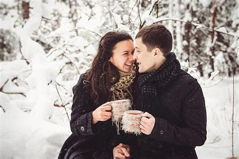 Couple In Winter Attire Taking A Snowy Walk Photo Background And Picture For Free Download - Pngtree