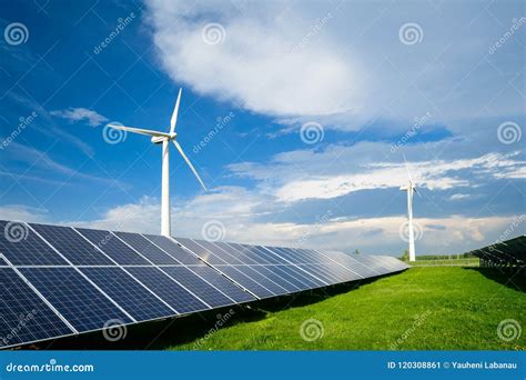 Solar Energy Panels And Windmills Against Blue Sky On Summer Day Stock