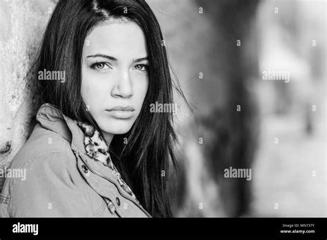 Portrait Of Brunette Young Woman With Green Eyes Wearing A Coat In