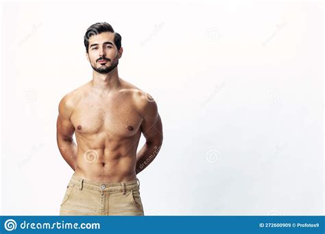 Man Athlete Model With A Naked Torso And Six Pack Abs Sporty Inflated Figure And Tan On A White