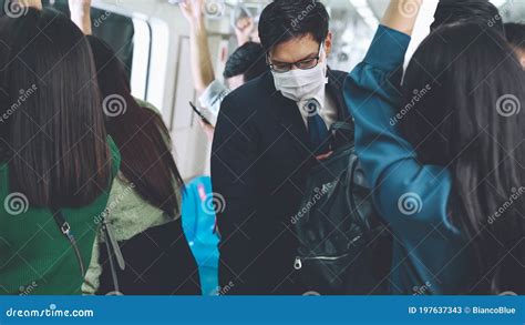 Young Man Wearing Face Mask Travels On Crowded Subway Train Stock Image