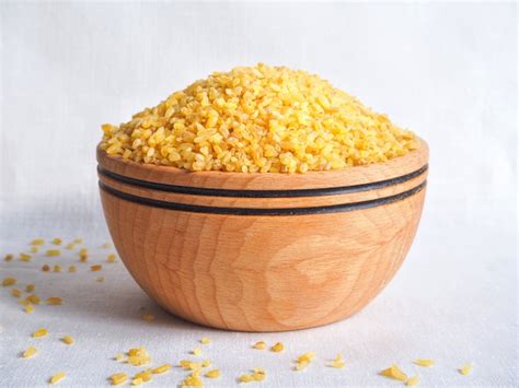 Premium Photo Dry Bulgur Wheat In Wooden Bowl Spilled Bulgur