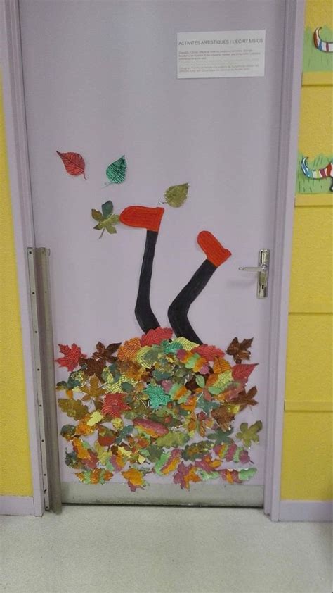 A Door Decorated With Fall Leaves And An Image Of A Man Laying On The