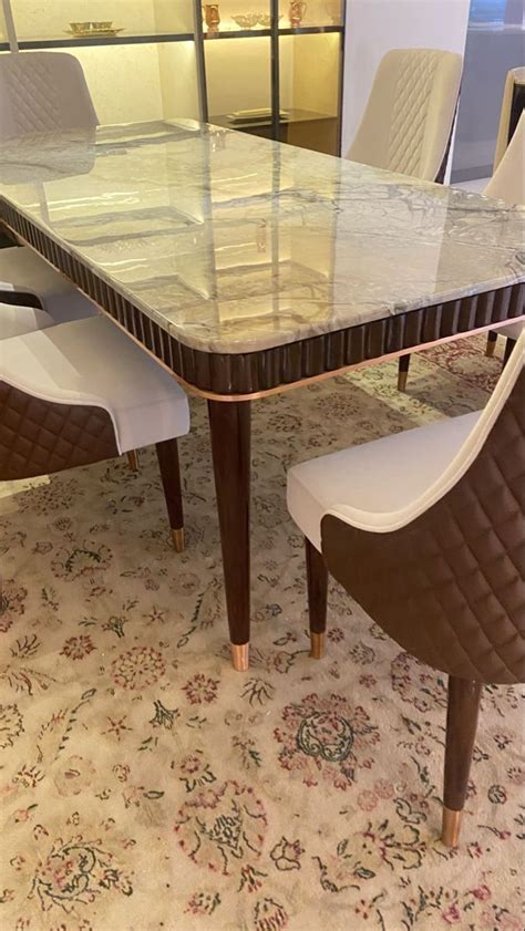 glass dining table  white chairs dining room  stone top table