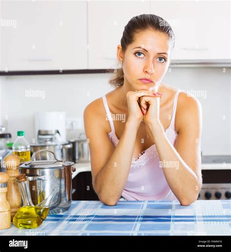 Tired Young Woman Leaning Her Elbows At The Kitchen Stock Photo Alamy