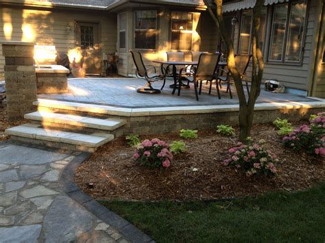 Beautiful Waterfall And Raised Patio Using Unilock Brick Pavers