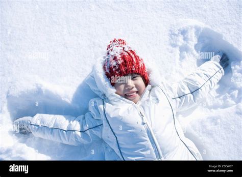 girl lying on snow field Stock Photo - Alamy