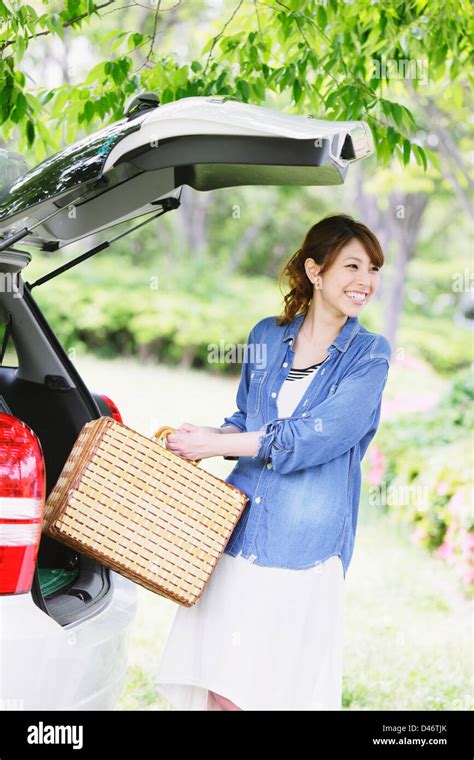 Woman Carrying A Picnic Basket Stock Photo Alamy