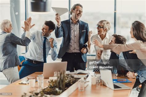 Large Group Of Cheerful Business People Celebrating Their Success In