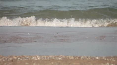 ocean waves washing beach sand. | Stock Video | Pond5