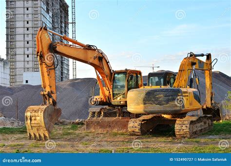 Wheel And Tracked Heavy Excavators Working At Construction Site