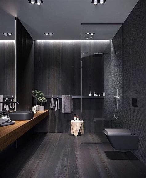 A Modern Bathroom With Black Walls And Wood Flooring